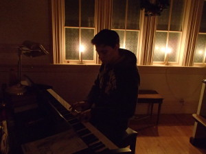 Savage practices on the church piano by candlelight!